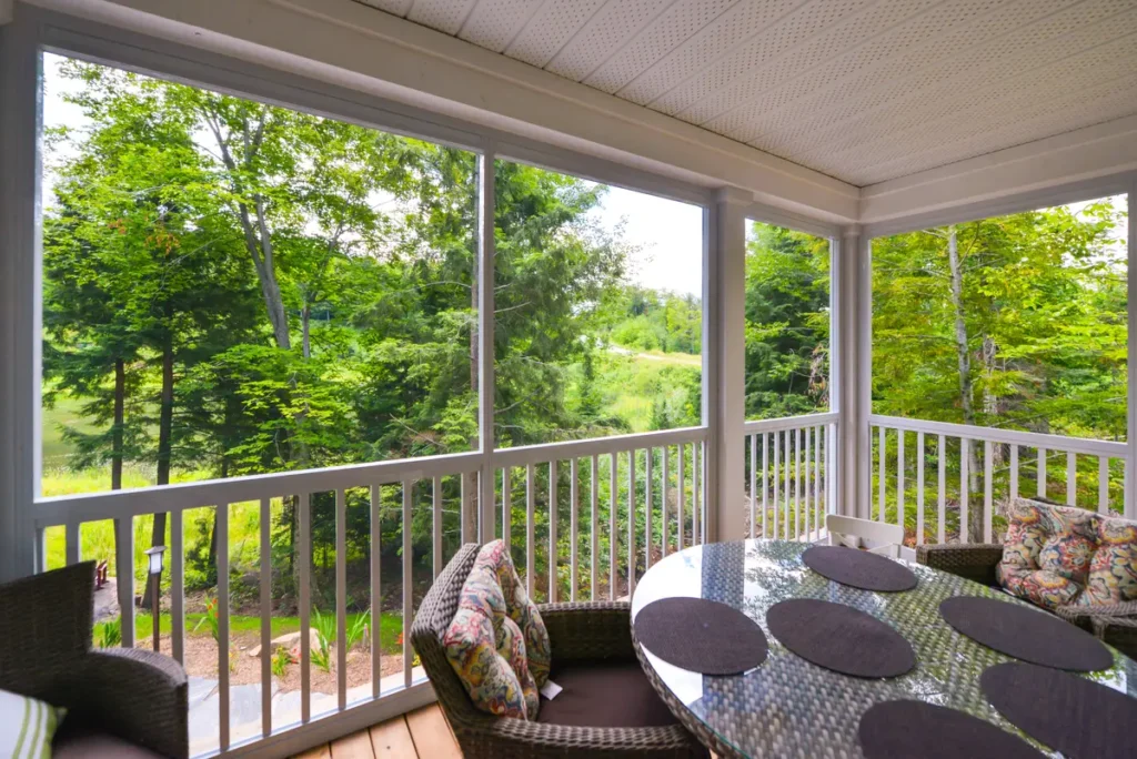 White-framed screen room with high-visibility mesh and a safety railing.